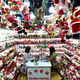 Women sit in a store selling Christmas products at the Yiwu Wholesale Market, Zhejiang province, Dec. 17, 2018.
